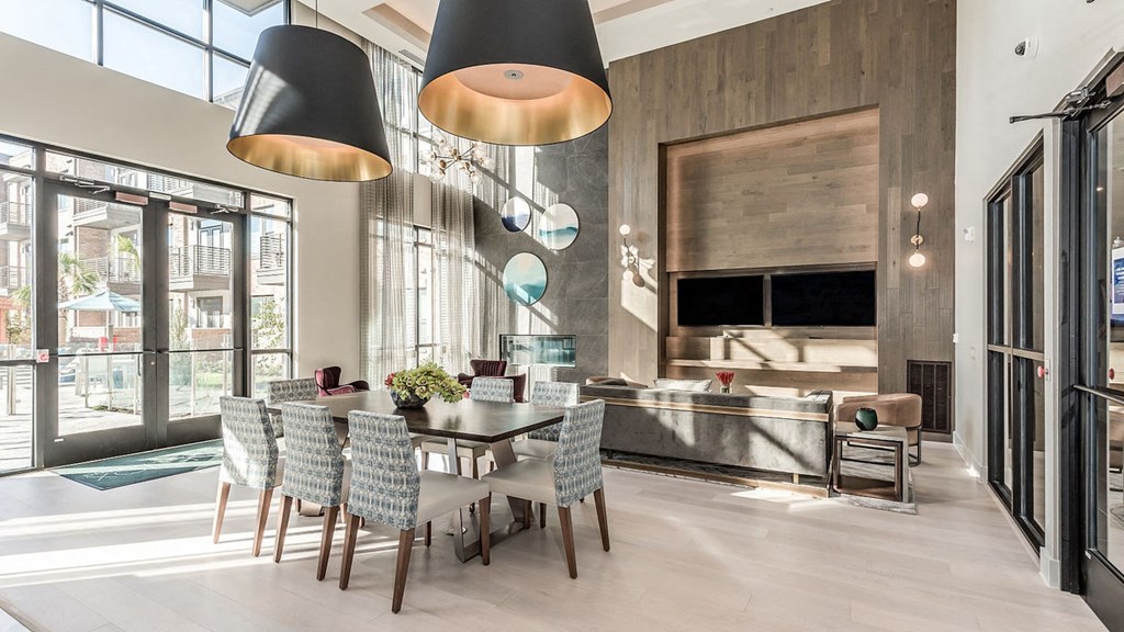 a dining room with a table and chairs and a kitchen with glass doors