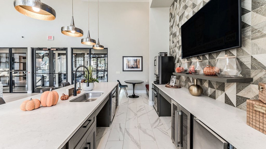 a kitchen with a sink and a television