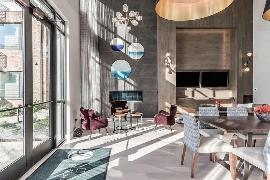 a dining room with a table and chairs and a large window