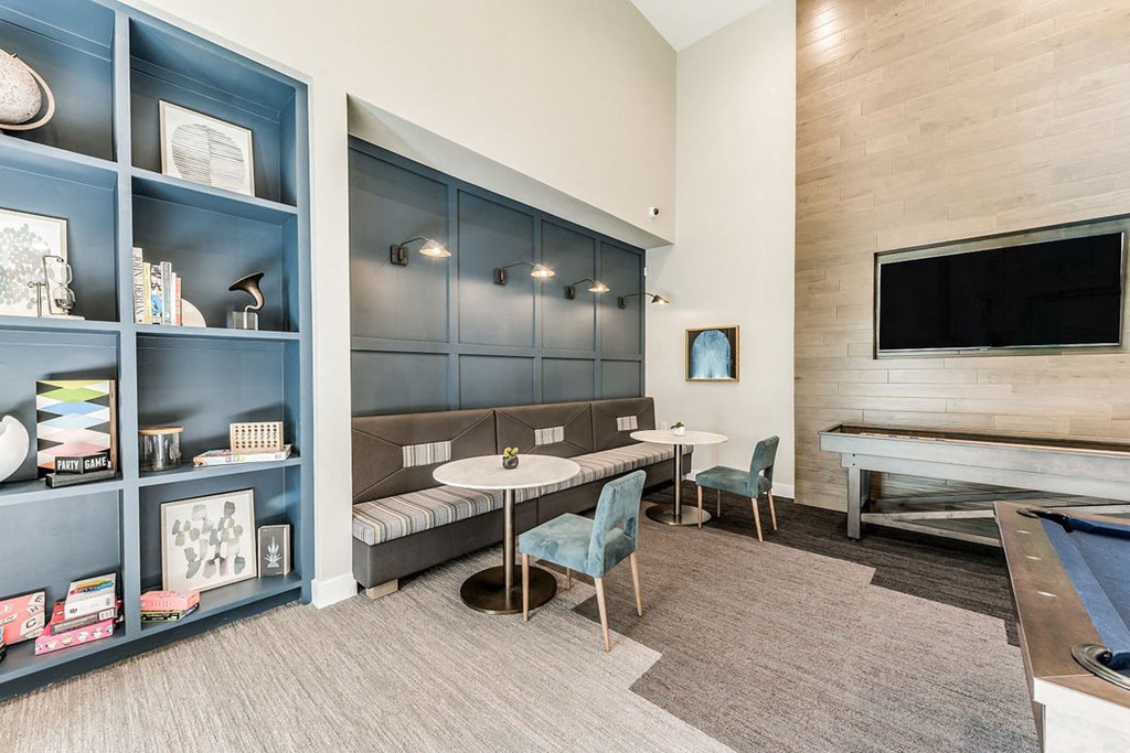 a living room with a tv and a table and chairs