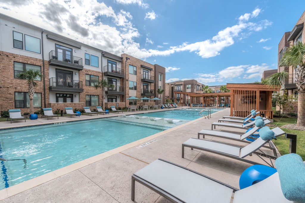 pool area with chairs at soneto on western apartments