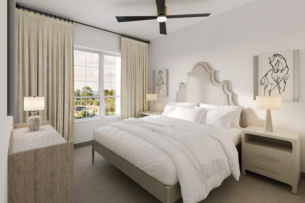 A bedroom with a large bed, two nightstands, and a ceiling fan.