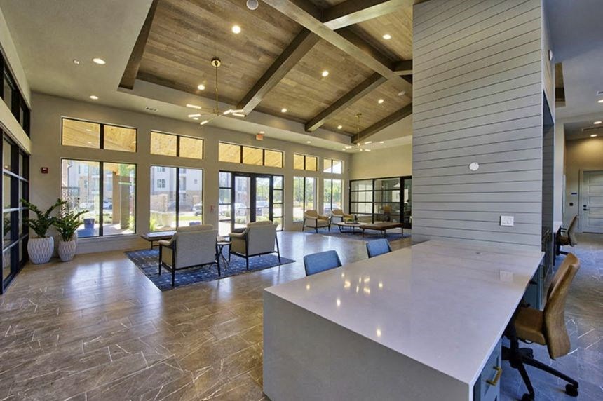 a large living room with a table and chairs