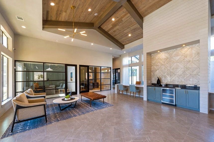 a large living room with a couch and a table