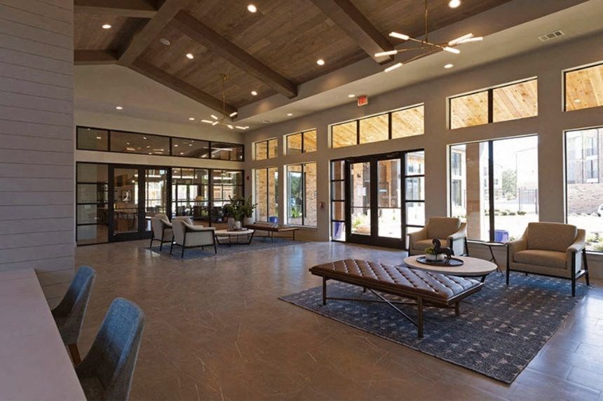 a large living room with chairs and a coffee table