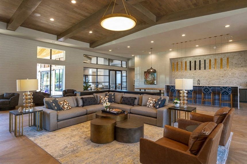 a living room with couches and chairs and a fireplace