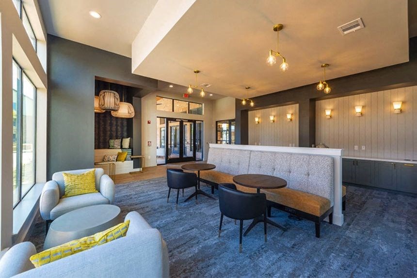 a living room with a couch and tables