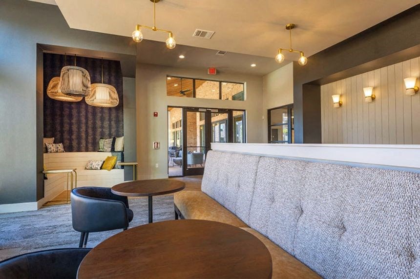a hotel lobby with a bar and tables