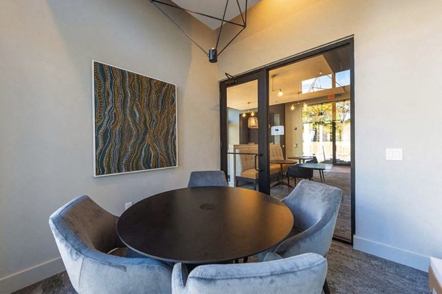 a dining room with a table and chairs