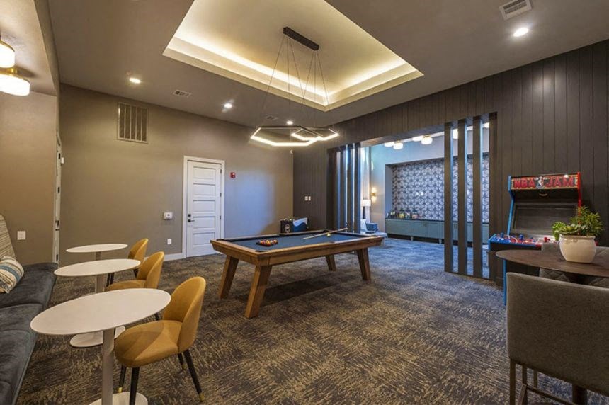 a game room with a pool table and a fireplace