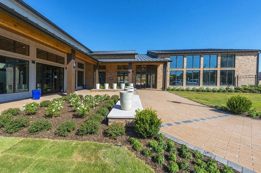 a courtyard in front of a building with a statue