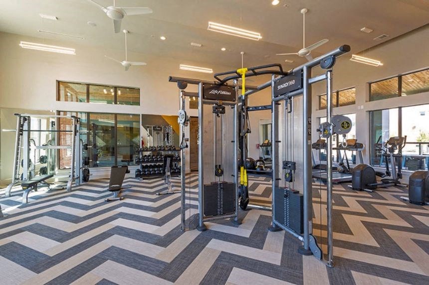 a gym with weights and other equipment in a building