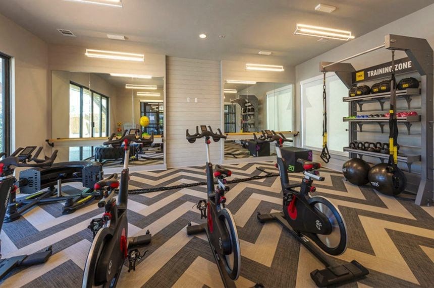 a gym with a lot of bikes and other exercise equipment