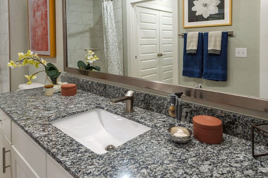 a bathroom counter with a sink and a mirror