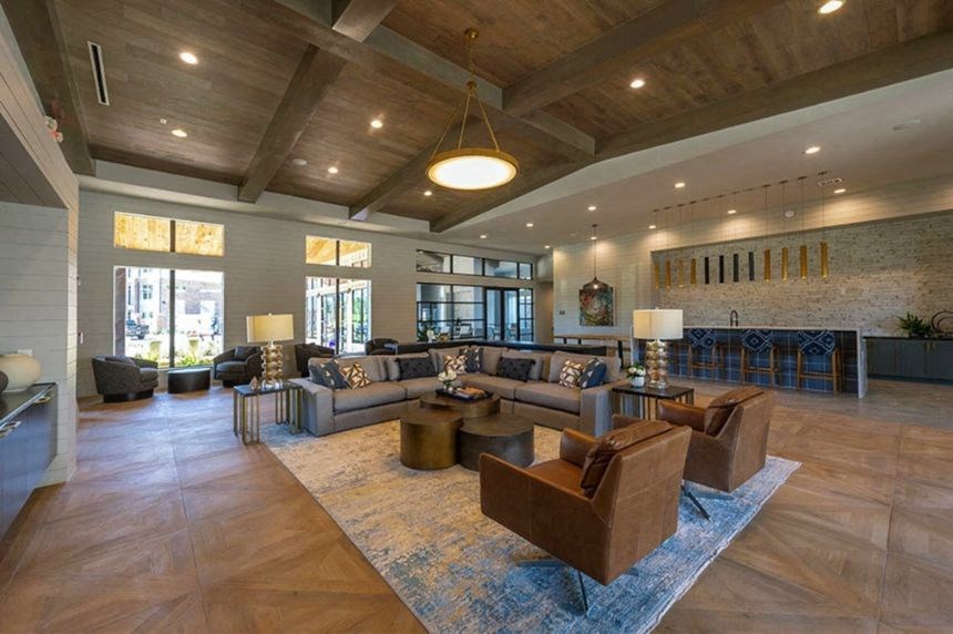 a large living room with couches and chairs