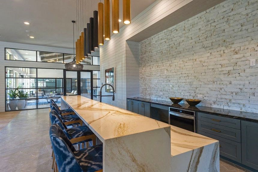 a large kitchen with a marble counter top