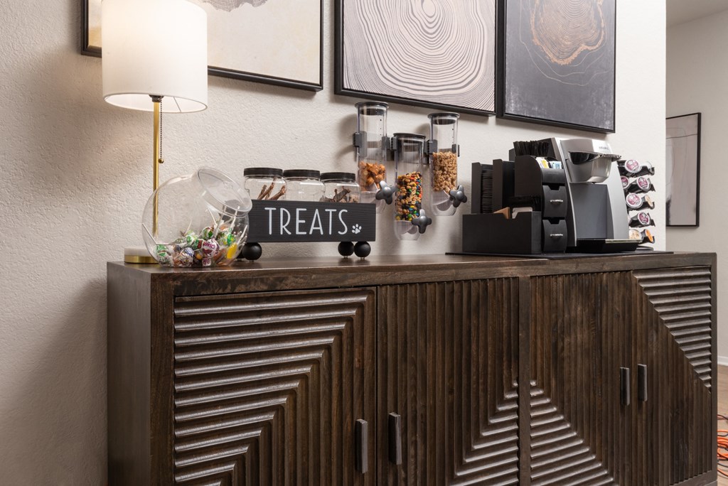 a coffee bar on a wooden dresser in a hotel room