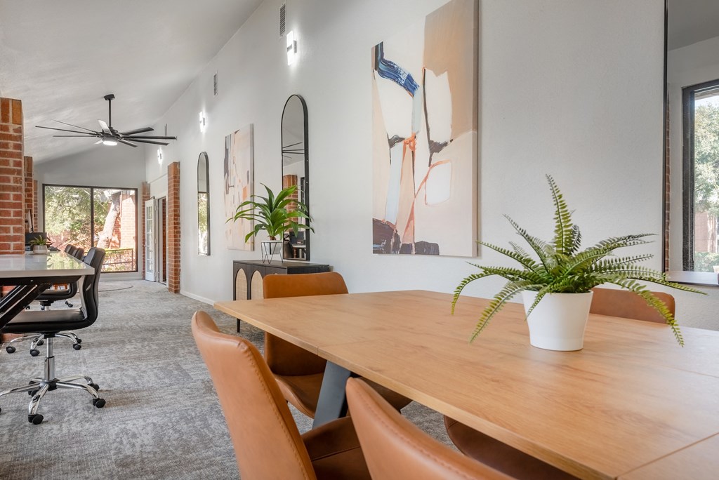 a dining room with a wooden table and chairs
