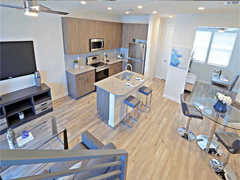 a view of a kitchen and living room with a table and chairs