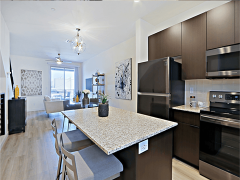 a kitchen and dining room with a marble counter top