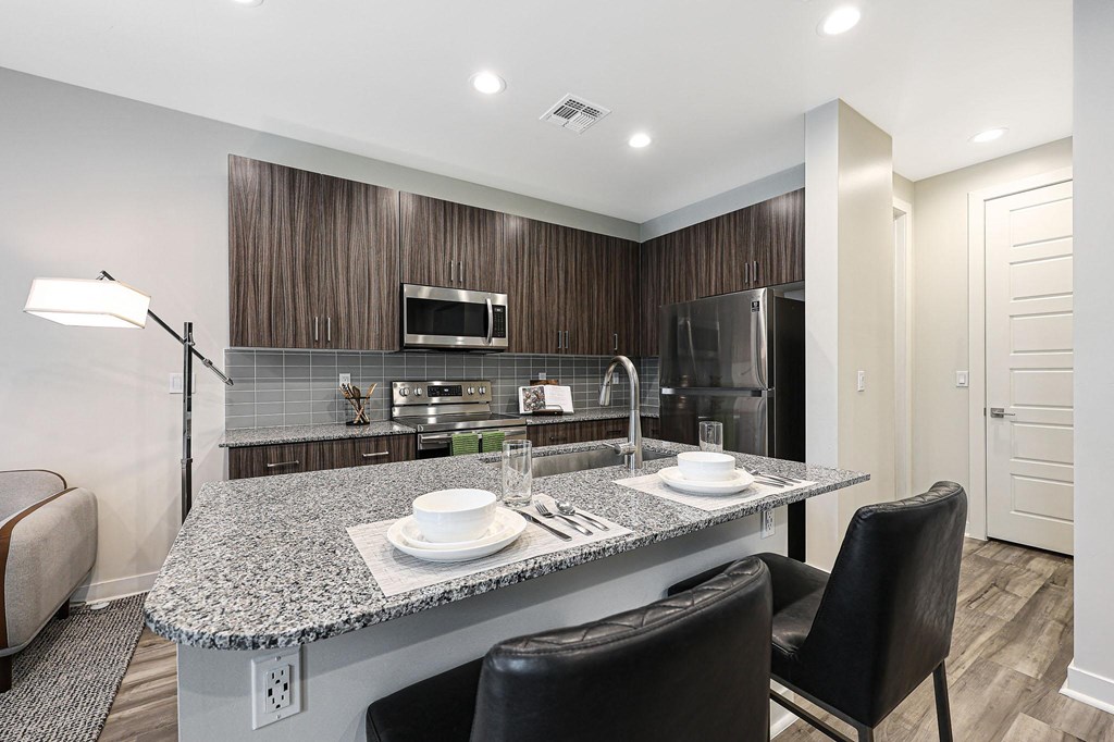 a kitchen with a large island with a granite countertop  at Scottsdale Hayden Townhomes, Arizona