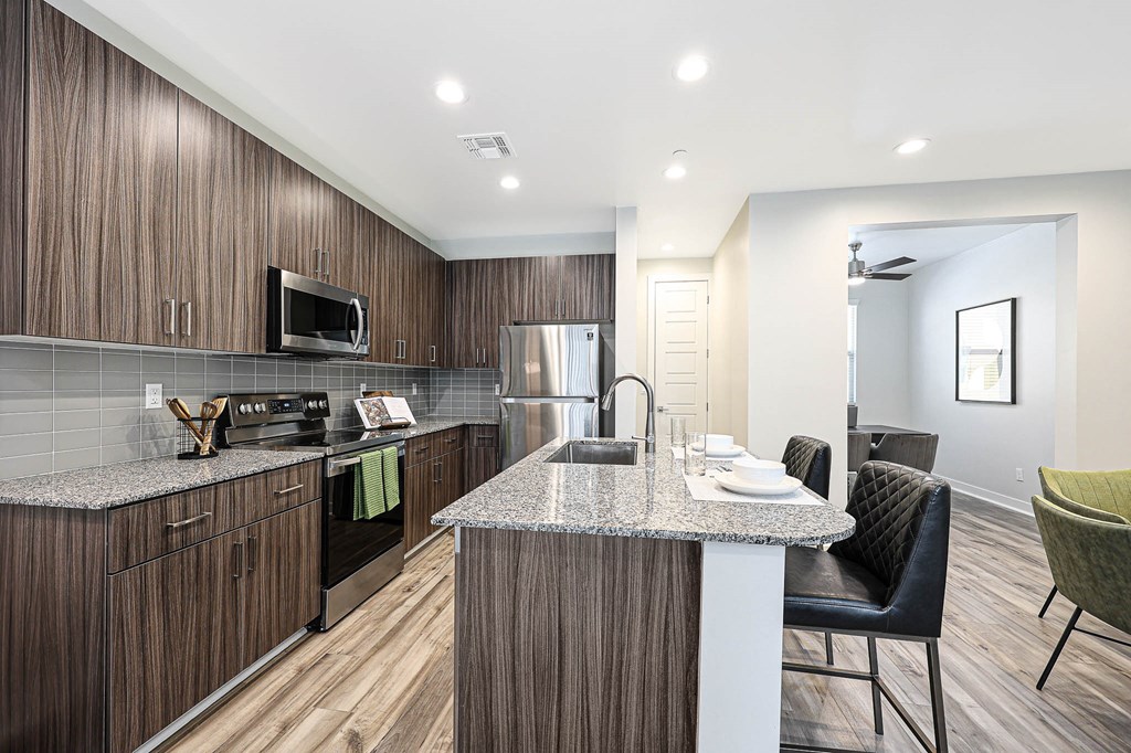 a kitchen with a large island with granite countertops  at Scottsdale Hayden Townhomes, Scottsdale, 85257