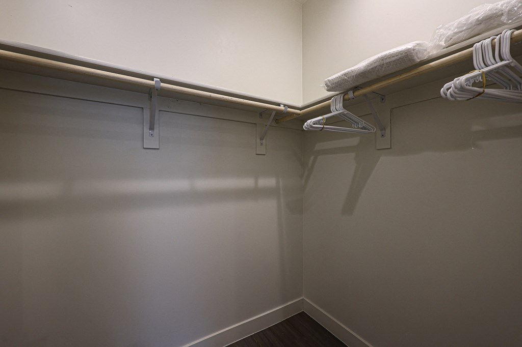 a walk in closet in a bedroom with grey walls and white trim at Scottsdale Hayden Townhomes, Arizona
