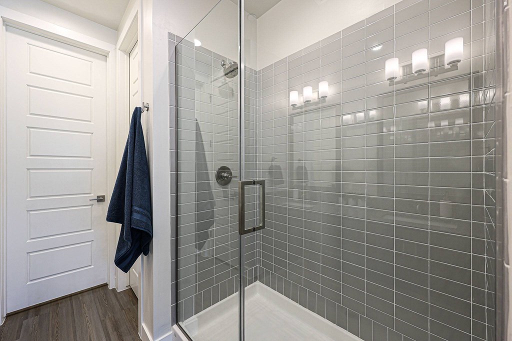 a bathroom with gray tiles and a glass shower door at Scottsdale Hayden Townhomes, Scottsdale, AZ, 85257