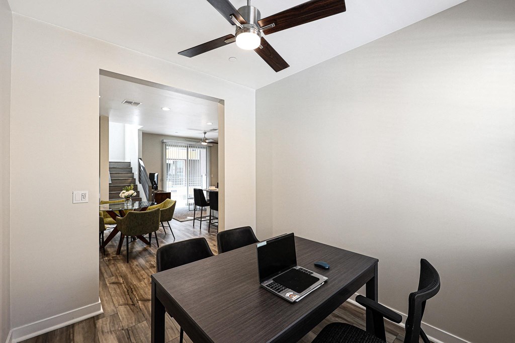 a room with a table and chairs and a ceiling fan  at Scottsdale Hayden Townhomes, Scottsdale, Arizona