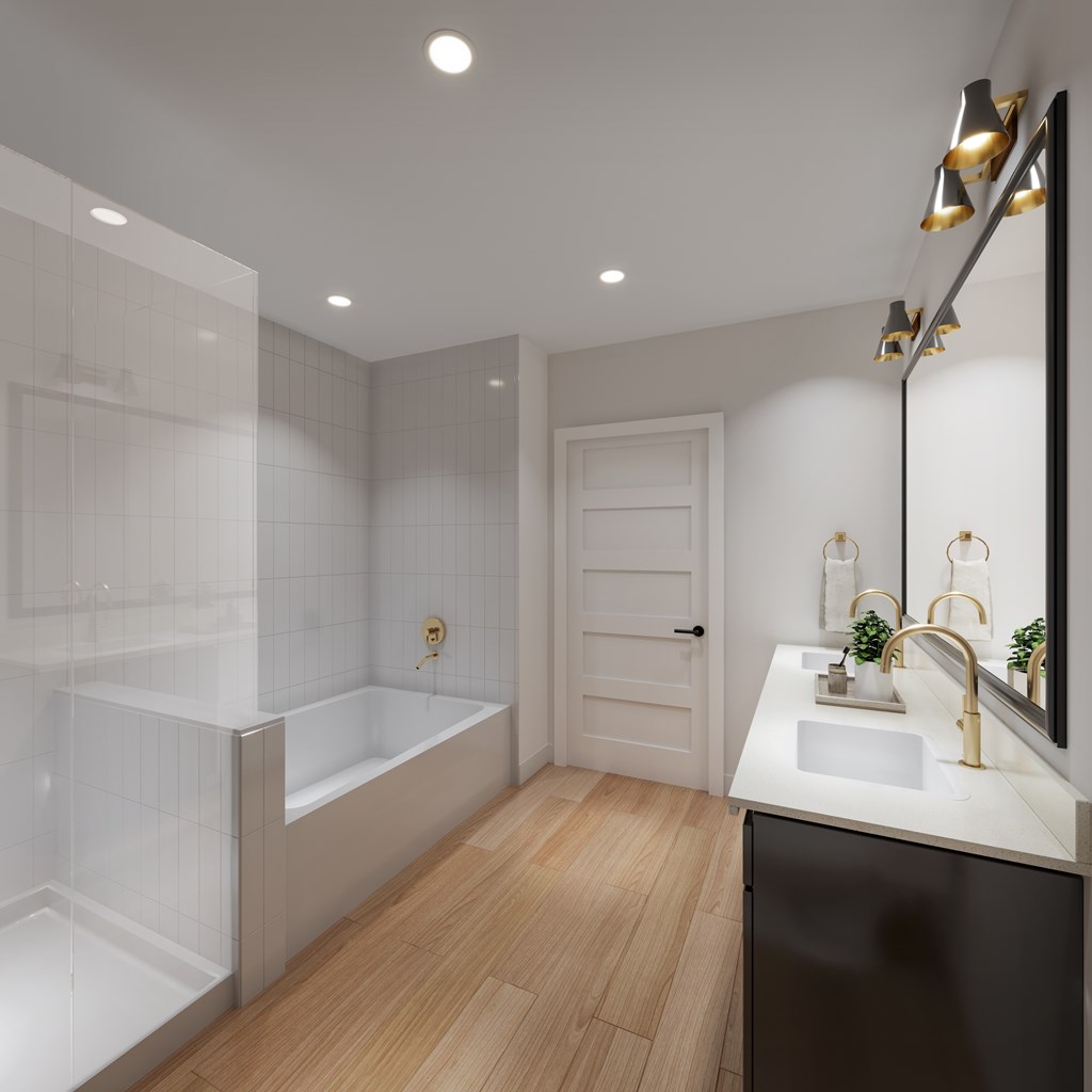 A modern bathroom with a white tub and sink.