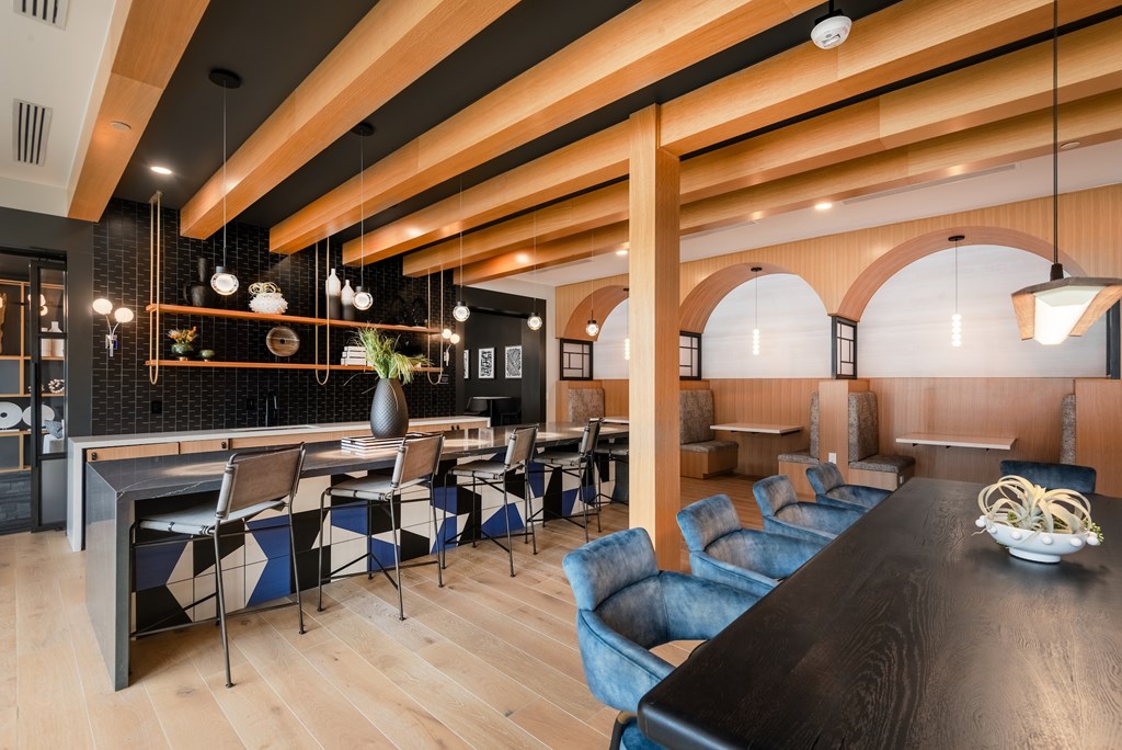 A modern dining area with a long table and chairs.