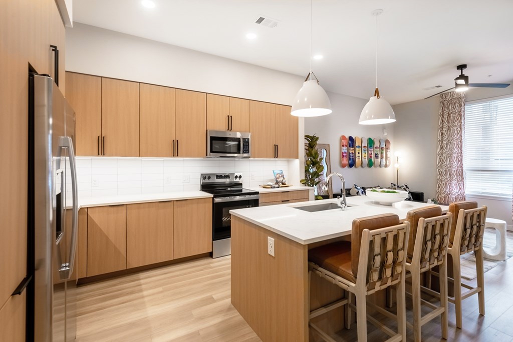A kitchen with wooden cabinets and a white countertop.