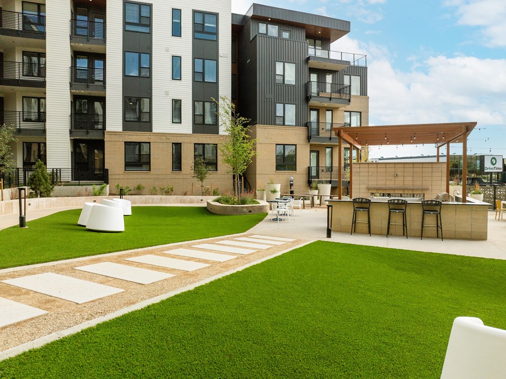 A modern building with a green lawn in front.