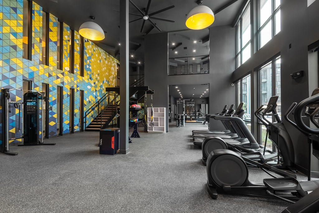A gym with treadmills and a staircase.