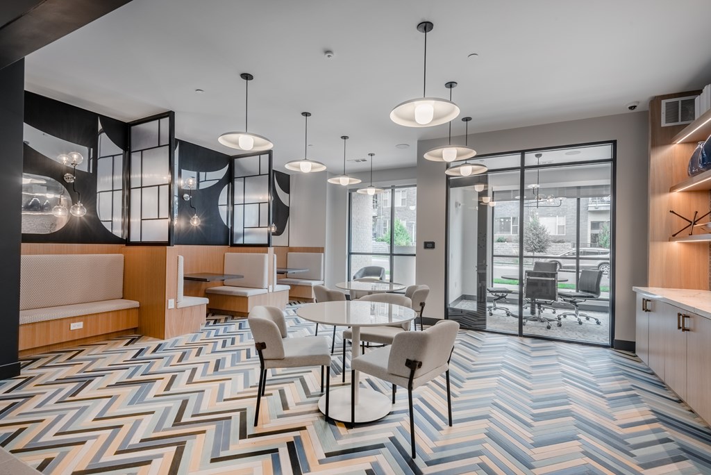A modern dining area with a chevron patterned floor and a view of the outdoors.