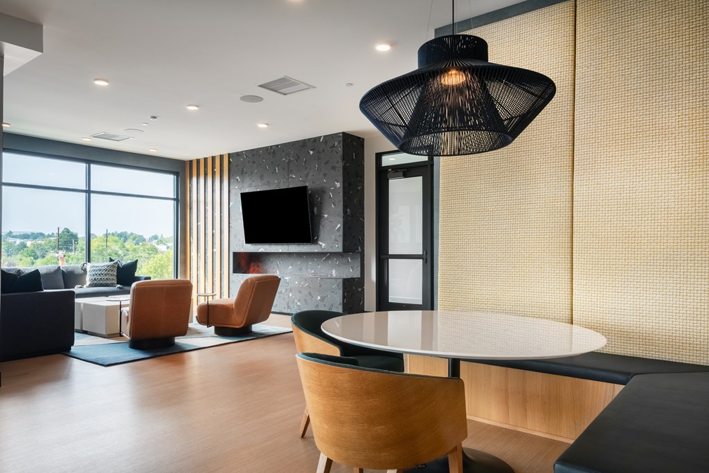 A modern living room with a large window and a flat screen TV.