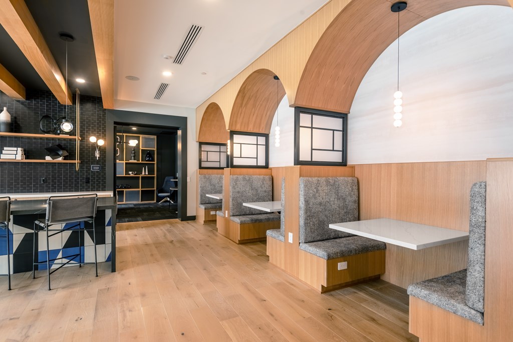 A modern cafe with wooden floors and furniture.