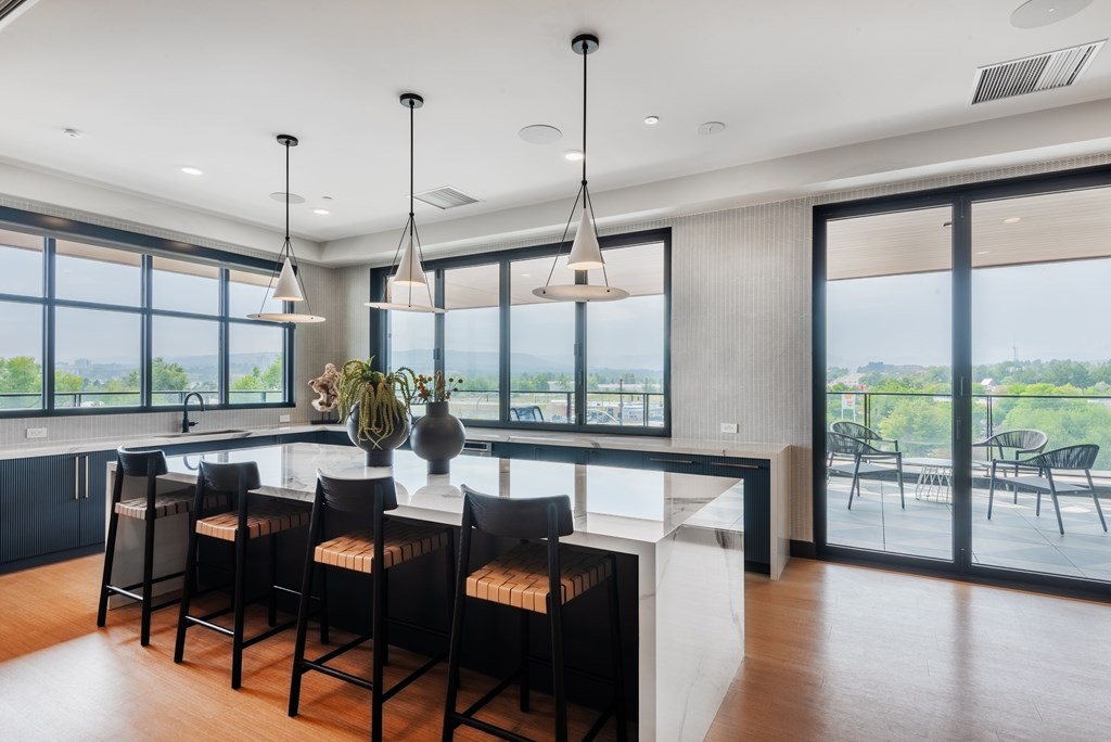 A modern kitchen with a large island and bar stools.