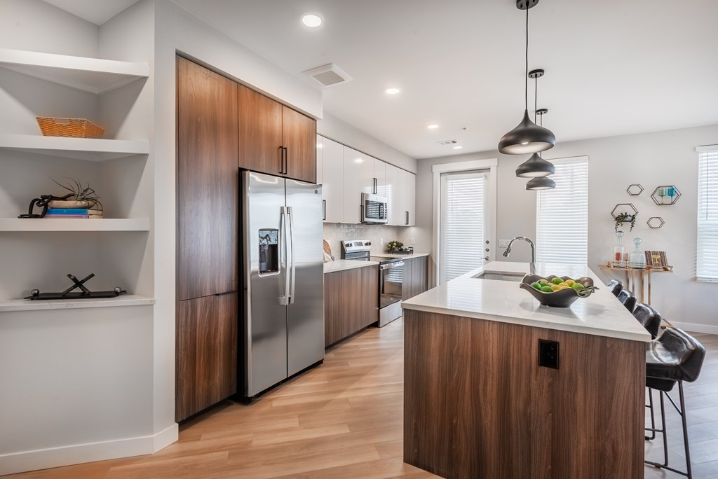 A modern kitchen with wooden cabinets and stainless steel appliances.