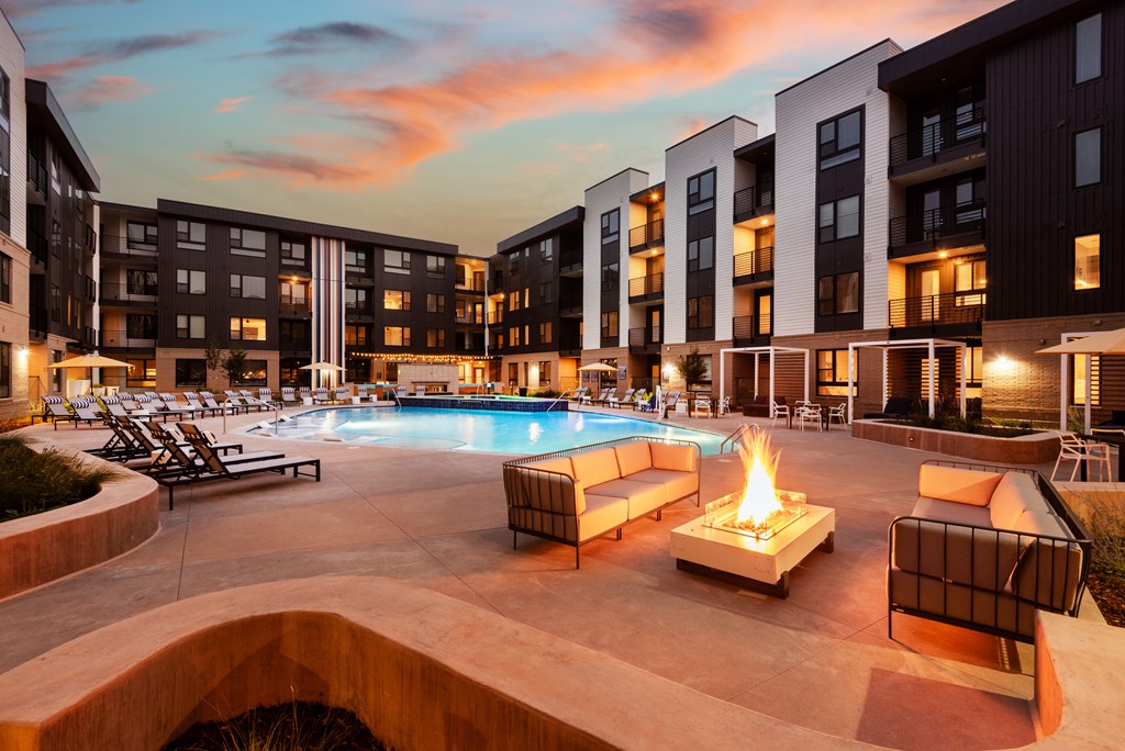 A pool with a fire pit in the middle of it.