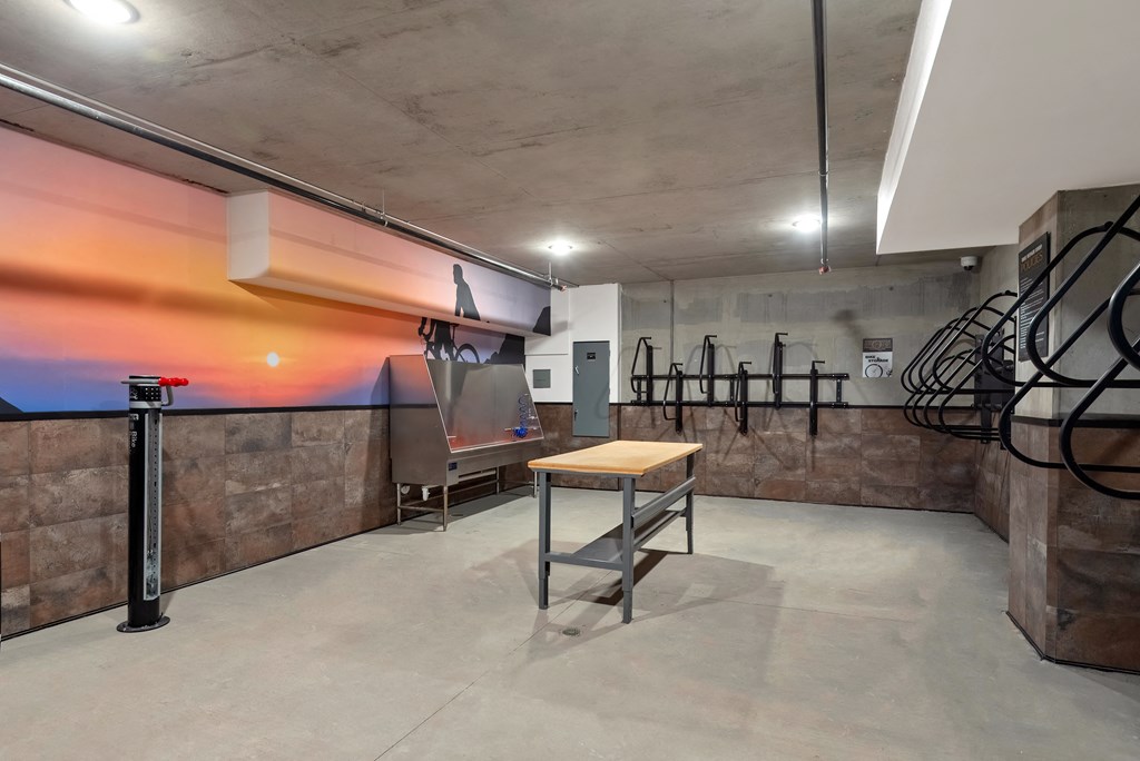A gym with a wooden table and a wall mural.