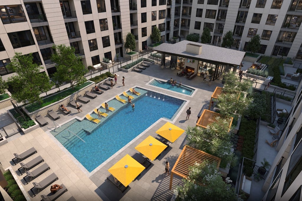 A pool area with a yellow sunbed and a yellow umbrella.