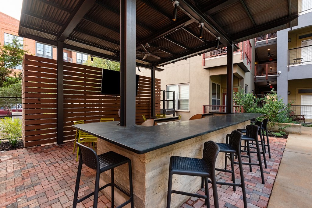 Patio with a bar and chairs  at The Can Plant Residences at Pearl, Texas