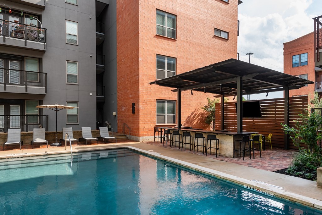 Swimming pool at The Can Plant Residences at Pearl, San Antonio, TX 78215 next to a building