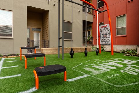 Outdoor space with benches and grass at The Can Plant Residences at Pearl, San Antonio, TX 78215and a white counter top  at The Can Plant Residences at Pearl, Texas, 78215