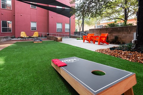 Outdoor Yard with a ping pong table and grass at The Can Plant Residences at Pearl, San Antonio, TX 78215and a white counter top  at The Can Plant Residences at Pearl, San Antonio, 78215