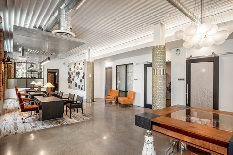 a large room with a table and chairs and a lobby at The Can Plant Residences at Pearl, San Antonio, 78215
