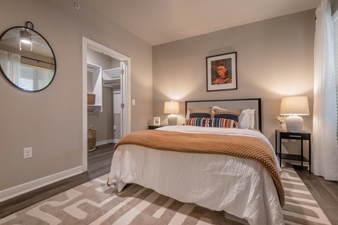 a bedroom with a bed and a door to a bathroom at The Can Plant Residences at Pearl, San Antonio, 78215