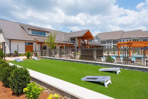 A modern building with a pool in the backyard.