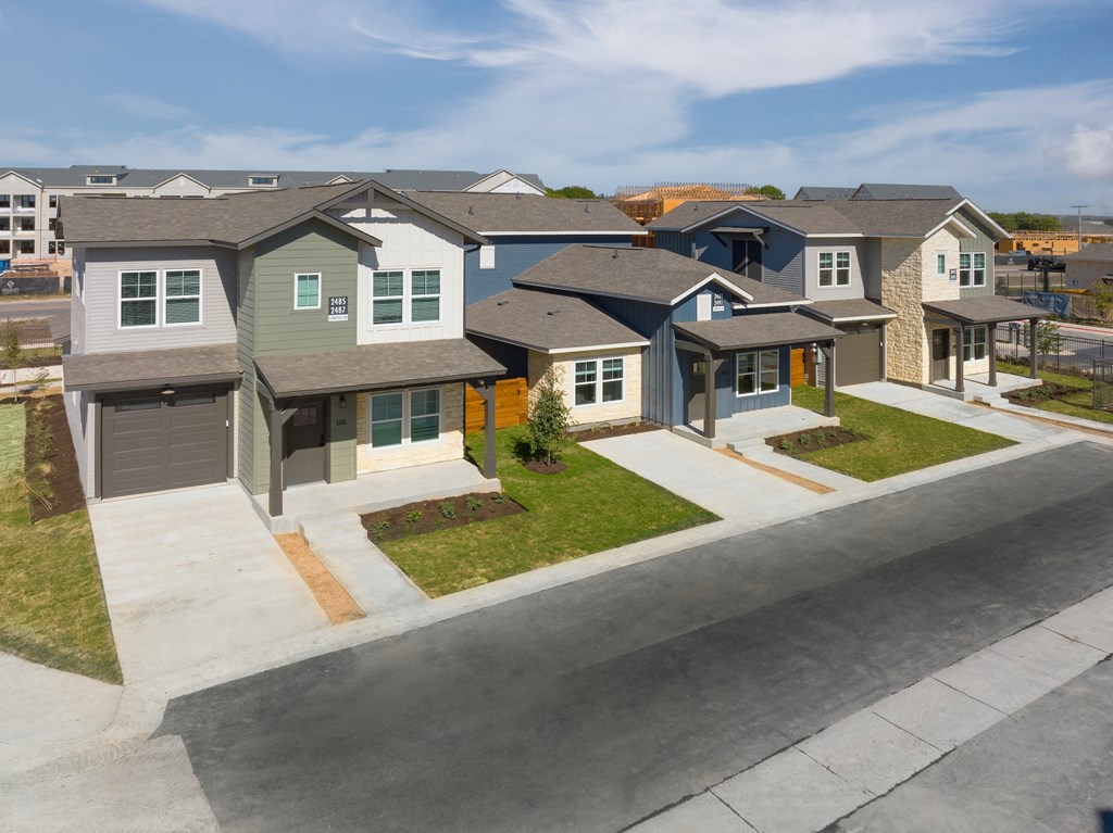 an aerial view of a group of houses on a street